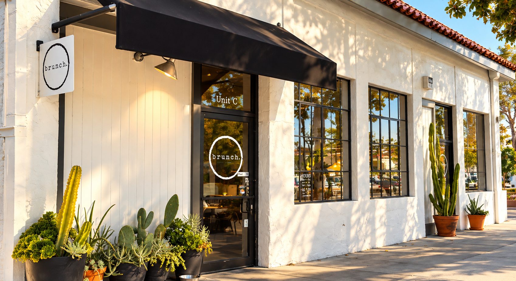 The storefront of Brunch in downtown Paso Robles, with potted cactus and succulents by the door