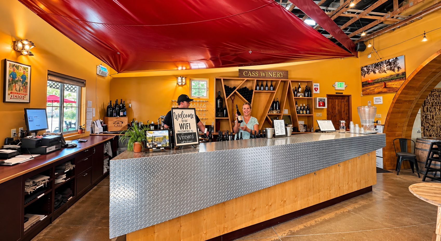 The tasting bar at Cass Winery, with a staff member holding up a bottle of wine