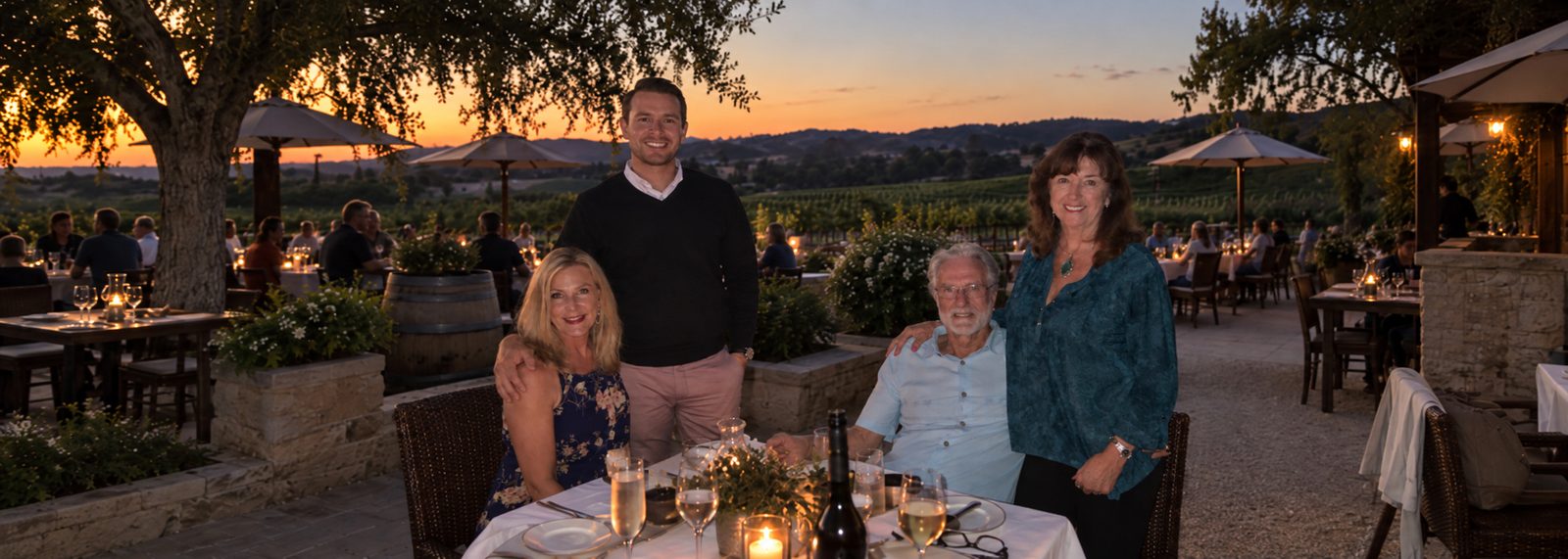 Family dinner on a wine country terrace at sunset