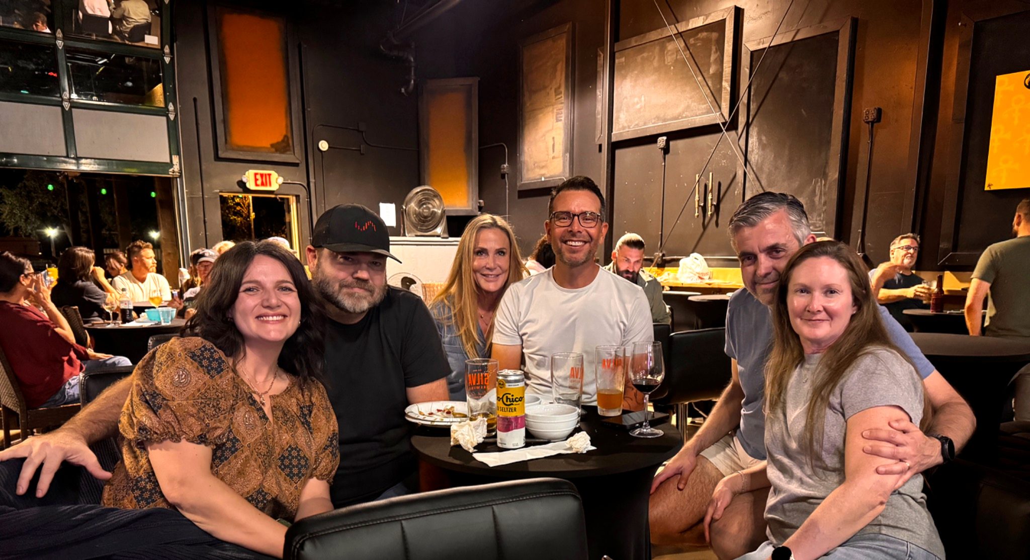 A group of friends gathered around a table at The Pour House, Paso Robles