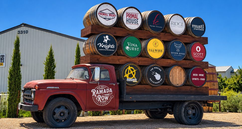 Ramada Row sign on a vintage truck loaded with barrels bearing merchant logos, Paso Robles